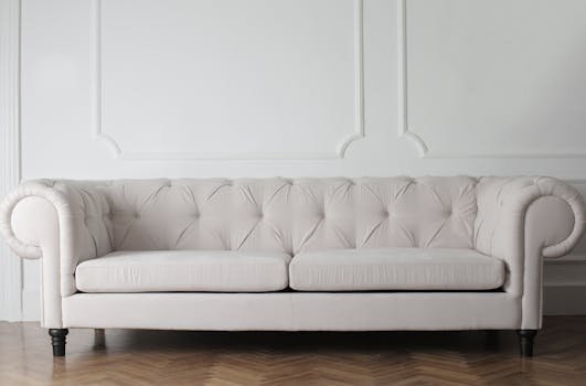 pexels-photo-3757055-3757055 Luxurious white sofa in a modern minimalist interior with wooden flooring.